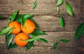Fresh Clementine or Mandarin orange with leaves on wooden background Royalty Free Stock Photo