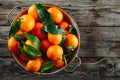 Fresh Clementine Mandarin Oranges fruits or Tangerines with leaves on wooden background Royalty Free Stock Photo