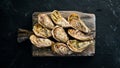 Fresh closed oysters. Seafood On a black stone background.