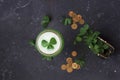 Fresh clover leaves from a green purse and gold coins are scattered on a dark background. St. Patrick`s Day concept. Copy space Royalty Free Stock Photo