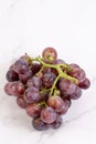 Fresh cluster of grapes on the grey marble
