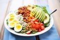 fresh cobb salad on white plate, blue cheese crumbs on top Royalty Free Stock Photo