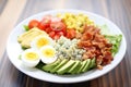 fresh cobb salad on white plate, blue cheese crumbs on top Royalty Free Stock Photo