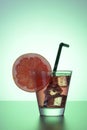 Fresh cocktail with grapefruit, ice and striped drinking straw. Royalty Free Stock Photo