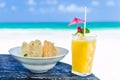 Fresh cocktail with orange juice and nachos on table at tropical exotic Caribbean beach Royalty Free Stock Photo