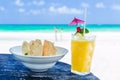 Fresh cocktail with orange juice and nachos on table at tropical exotic Caribbean beach Royalty Free Stock Photo