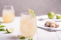 Fresh cocktail prepared with ginger beer, lime and ice. White table Royalty Free Stock Photo