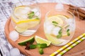 Fresh cocktail with soda, lime and lemon on a wooden background Royalty Free Stock Photo