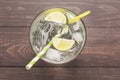 Fresh cocktail with soda, lime on a wooden background