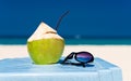 Fresh coconut cocktail and blue sunglasses Royalty Free Stock Photo