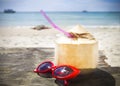 Fresh coconut cocktail and red sunglasses on the beach Royalty Free Stock Photo