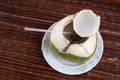 Fresh coconut fruit drink on a table with drinking straw. Royalty Free Stock Photo