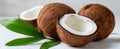 The Fresh Coconut Halves with Green Leaves on a Bright Background AI generated image Royalty Free Stock Photo
