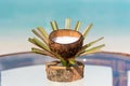 Fresh coconut milk in designed cup on the glass table at the beach with ocean background Royalty Free Stock Photo