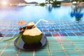 Fresh Coconut from tree ready to drink straw, place nicely along Blue Pool Royalty Free Stock Photo