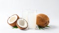 Fresh coconut water in glasses with whole and halved coconuts on white background Royalty Free Stock Photo