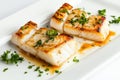 Fresh cod fish fillets served with parsley on a white plate for gourmet dining experience Royalty Free Stock Photo