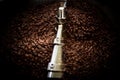 Fresh coffee beans and roasted spinning cover professional machine close up photo blur and dark background long exposure shot