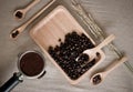 Fresh coffee beans, wood spoons and coffee maker on the desktop Royalty Free Stock Photo