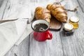 Fresh coffee cup with freshly baked croissants and jam jars.Coffee breakfast Royalty Free Stock Photo