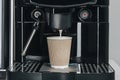 Coffee from coffee machine brewing to paper cup Royalty Free Stock Photo