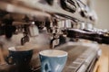 Fresh coffee prepared in the a coffee machine. Espresso in small white cups