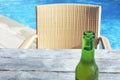 Fresh cold beer drink served on a poolside table in a tropical r Royalty Free Stock Photo