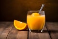 Fresh cold glass of orange juice with ice cubes inside on the table Royalty Free Stock Photo
