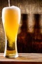 Fresh cold light beer pouring into glass with drops of water on Royalty Free Stock Photo