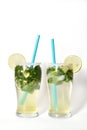 Fresh and cold Mojito cocktail on a white background. Two mojitos with drinking straw Royalty Free Stock Photo