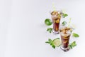 Fresh cold summer drink of cola, ice, lime, leaf mint on soft light white background, copy space, top view. Royalty Free Stock Photo