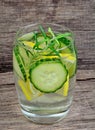 Fresh cold water with lemon, cucumber and rosemary in a glasses on old table Royalty Free Stock Photo