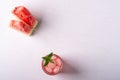 Fresh cold watermelon juice with ice cubes and green mint leaf in glass drink close to two slices of watermelon, top view Royalty Free Stock Photo