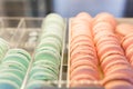 Fresh colored macaroons close-up, sale in coffee shop showcase.
