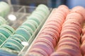 Fresh colored macaroons close-up, sale in coffee shop showcase.