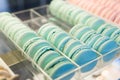 Fresh colored macaroons close-up, sale in coffee shop showcase.