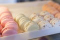 Fresh colored macaroons close-up, sale in coffee shop showcase.