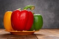 Fresh colorful bell peppers with drips on table Royalty Free Stock Photo