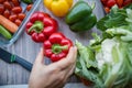 Fresh and colorful bell peppers and other vegetables on wooden table Royalty Free Stock Photo