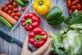 Fresh and colorful bell peppers and other vegetables on wooden table Royalty Free Stock Photo