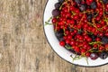 Fresh colorful berries in bowl on rustic wooden table Royalty Free Stock Photo