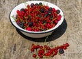 Fresh colorful berries in bowl on rustic wooden table Royalty Free Stock Photo