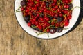 Fresh colorful berries in bowl on rustic wooden table Royalty Free Stock Photo