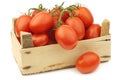 Fresh and colorful italian roma tomatoes on the vine in a wooden crate Royalty Free Stock Photo