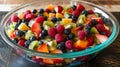 Fresh, Colorful Mixed Fruit Salad in Glass Bowl on Wooden Table Royalty Free Stock Photo