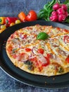 Fresh, colorful pizza with vegetables and a cutter