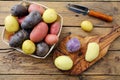 Fresh colorfull potatoes on rustic table background