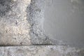 Fresh concrete mixture spreads over an old rough ground surface during active construction work Royalty Free Stock Photo
