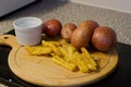 Chips With Raw Potatoes In The Background & Sea Salt Royalty Free Stock Photo