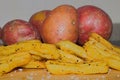 Home Made Style Chips  With Raw Potaoes In The Background Royalty Free Stock Photo